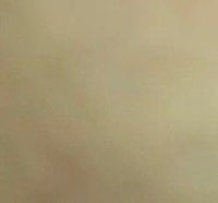 a woman is standing in front of a wall